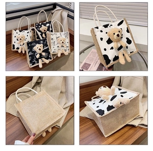 Detail of canvas tote bags with cute 3D plush bear charms and cow print patterns