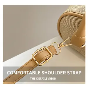 Detail of adjustable shoulder strap with gold buckle on a woven patchwork bag