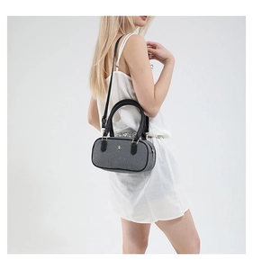 Model wearing a grey textured Boston bag with black handles and gold logo detail