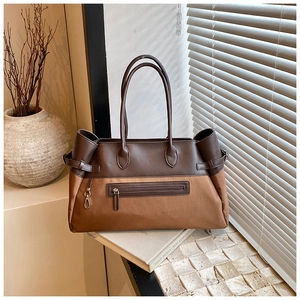 Detail of the high-capacity tote bag showing two-tone synthetic leather and canvas texture