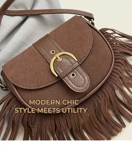 Close-up of vintage brown crossbody bag with matte suede fringe and golden metal buckle