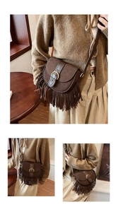 Detailed close-up of a vintage coffee brown suede crossbody bag with long tassels
