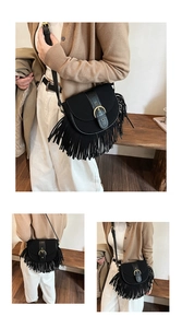 Detailed view of a black fringe saddle bag with matte texture and gold buckle hardware