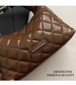 Detail of dark brown quilted leather finish with metal buckle and fashion logo plate