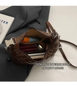 Interior view of quilted dark brown shoulder bag showing spacious storage for daily items