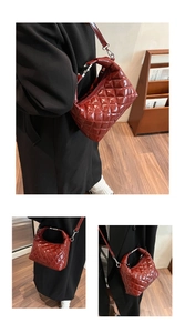 Close-up of wine red quilted patent leather shoulder bag with silver hardware and strap