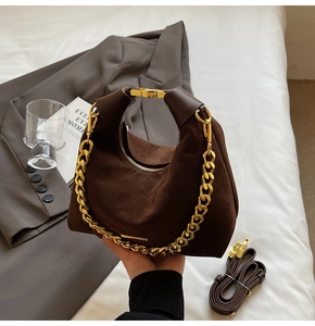 Gros plan sur le sac à main en daim marron avec chaîne dorée décorative
