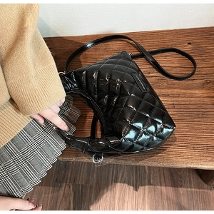 Close-up of black quilted leather handbag showing premium stitching and brand logo