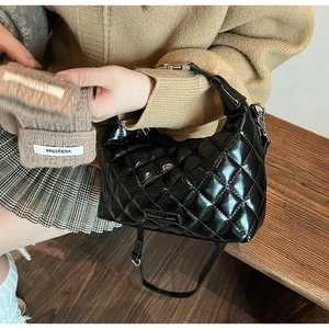 Detail of black glossy quilted hobo bag with Fashion & Bags logo and silver hardware