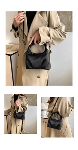 Close-up of black pleated leather handbag with soft cloud handle and silver zipper details