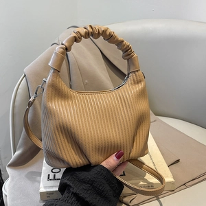 Khaki pleated hobo bag with cloud handle and adjustable strap for women in office setting