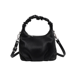 Fashionable black pleated crossbody bag with a cloud handle and glossy leather finish
