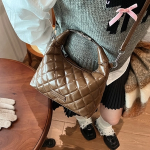 Brown quilted glossy shoulder bag with metal handle and elegant crossbody strap