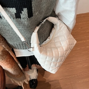 White quilted crescent shoulder bag in glossy faux leather with adjustable silver hardware
