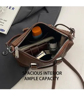 Interior view of brown quilted bag showing large capacity for phone and wallet