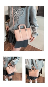 Detail of pink pleated PU leather tote bag showing fine vertical textures and silver hooks