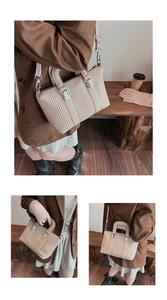 Detail of beige pleated handbag showing fine vertical stripes and silver hardware accents