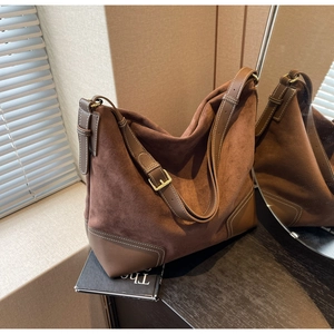 Detail of vintage suede brown Boston bag with smooth leather trim and metal buckle