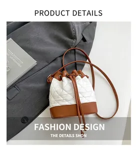 Close-up of quilted bucket bag with brown drawstring and leather trim on grey blazer
