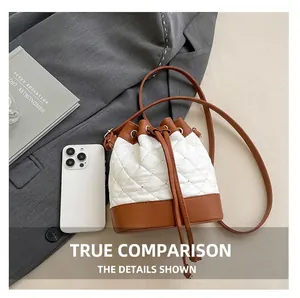 Detailed top view of the quilted bucket bag with drawstring closure and two-tone color