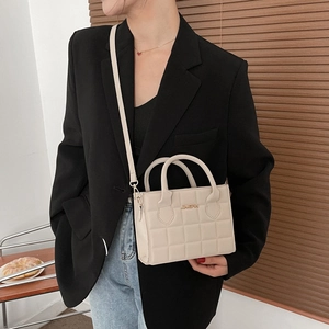Minimalist beige quilted square handbag with gold logo for elegant daily commute fashion