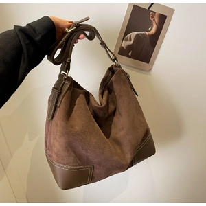 Detailed view of the vintage brown suede texture and stitching on this large tote bag