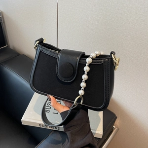 Women's black panelled handbag with pearl chain strap and gold magnetic buckle