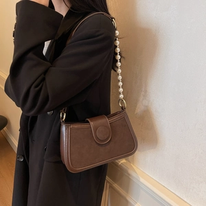 Brown vintage faux leather crossbody bag featuring an elegant oversized pearl chain strap