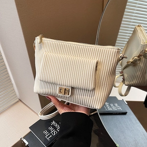 Chic cream corduroy shoulder bag with gold twist-lock and elegant chain strap details