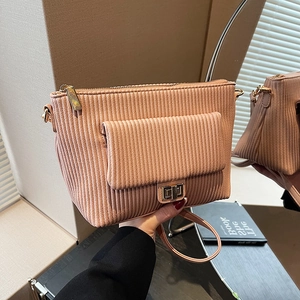 Pink corduroy crossbody bag with gold twist lock and adjustable strap for women