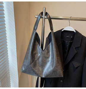 Detail shot of the large charcoal grey tote bag with unique vintage washed texture