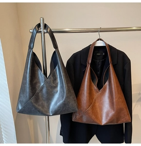 Detail of diagonal stitching and matte leather texture on large capacity hobo bags