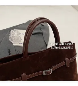 Macro view of dark brown frosted tote bag with sturdy leather handles and fine stitching