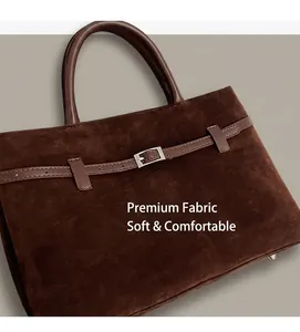 Close-up of brown frosted suede tote bag detailing fine texture and silver metal buckle