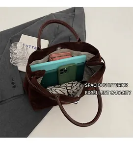 Top view of open dark brown frosted tote bag showing large capacity for daily items