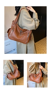 Brown lychee-textured tote bag with metal cross pendant and side zipper details