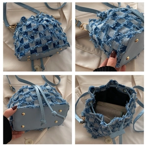 Detail view of light blue denim bucket bag featuring distressed checkerboard texture and base
