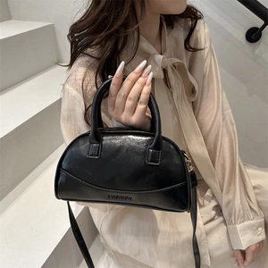 Chic black glossy shell bag with FASHION embossing and matching shoulder strap