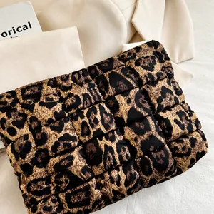Close-up of leopard print quilted cosmetic bag with stitching detail on a lifestyle background