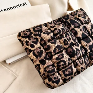 Detail view of quilted leopard print clutch featuring high-quality stitching and fabric
