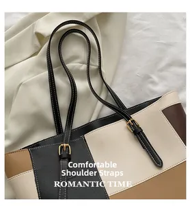 Detailed view of comfortable shoulder straps on a tricolor patchwork tote bag