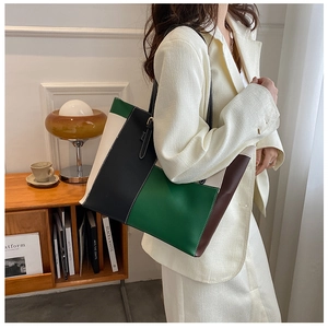 Detail view of large color-block tote bag with geometric stitching and slim straps