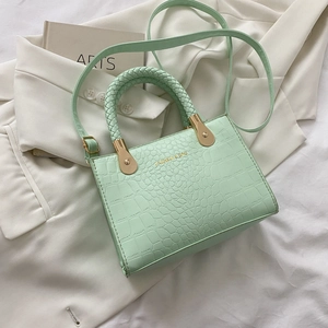 Detailed macro view of mint green crocodile pattern faux leather with gold fashion text