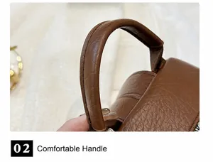 Detail of soft brown pebble leather top handle with reinforced stitching on casual backpack