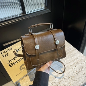 Vintage brown leather crossbody satchel bag with dual silver rings and top handle