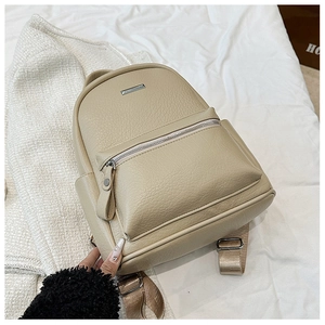 Detail of apricot pebbled leather texture and silver zipper on a fashion backpack