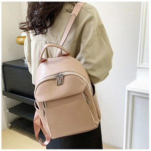 Detail of adjustable pink fabric straps and textured leather on a casual women's backpack