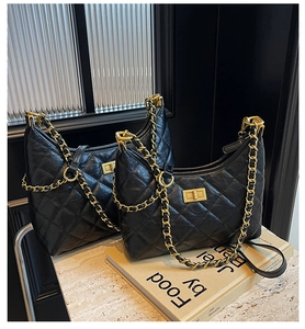 Close-up of black quilted leather hobo bags featuring elegant gold chain straps and metal locks