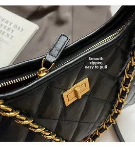 Detail of vintage quilted chain tote featuring a gold twist lock and smooth zipper
