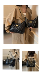 Detail of black quilted hobo bag with gold-tone chain strap and classic turn-lock